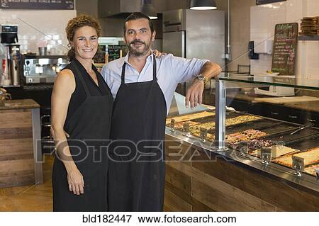 Stock Photo - Caucasian business owners smiling in cafe. Fotosearch