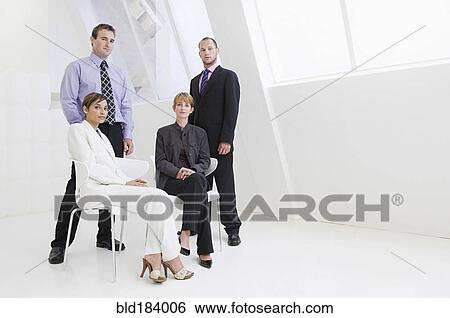 Stock Photograph - Caucasian business people posing in modern office. Fotosearch