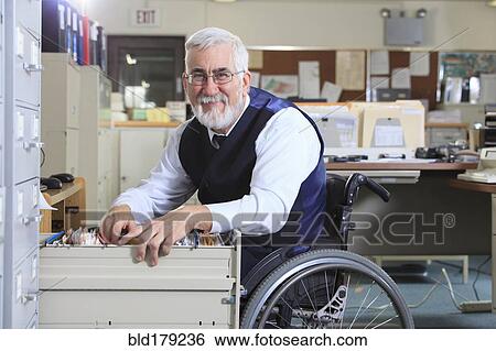 Caucasian businessman filing papers in office View Large Photo Image Stock Photograph - Caucasian businessman filing papers in office. Fotosearch