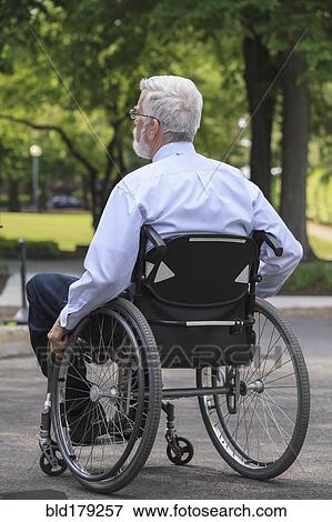 Stock Photo - Caucasian businessman in wheelchair outdoors. Fotosearch