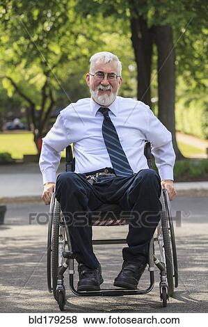 Stock Photo - Caucasian businessman in wheelchair outdoors. Fotosearch