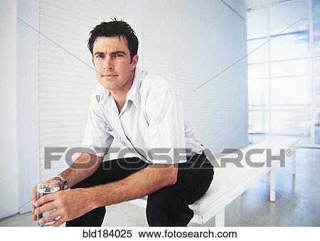 Stock Photography - Caucasian businessman sitting in office. Fotosearch