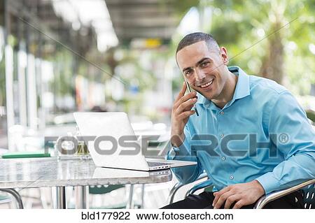 Caucasian businessman talking on cell phone in cafe View Large Photo Image Stock Image - Caucasian businessman talking on cell phone in cafe. Fotosearch