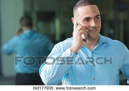 Stock Photography - Caucasian businessman talking on cell phone. Fotosearch