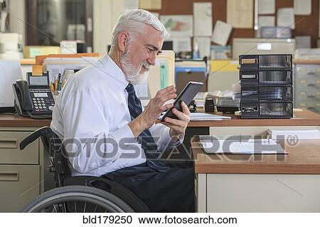 Caucasian businessman using digital tablet in office View Large Photo Image Stock Image - Caucasian businessman using digital tablet in office. Fotosearch