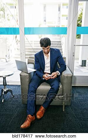 Stock Photo - Caucasian businessman using digital tablet in office. Fotosearch