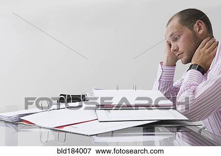 Stock Photo - Caucasian businessman working in office. Fotosearch