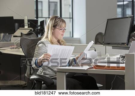 Stock Photo - Caucasian businesswoman with Down Syndrome working in office. Fotosearch