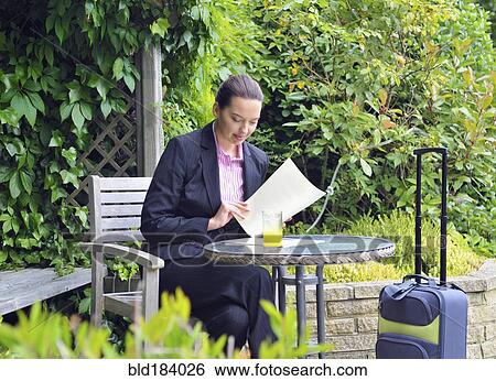 Caucasian businesswoman working in garden View Large Photo Image Stock Photograph - Caucasian businesswoman working in garden. Fotosearch