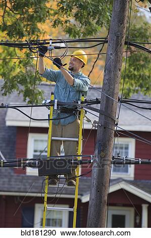 Caucasian cable installer working on ladder View Large Photo Image Stock Image - Caucasian cable installer working on ladder. Fotosearch