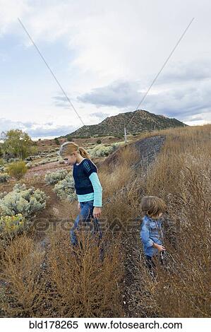 Stock Photography - Caucasian children exploring hillside. Fotosearch