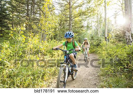 Caucasian children riding mountain bikes View Large Photo Image Stock Image - Caucasian children riding mountain bikes. Fotosearch