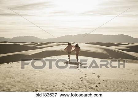 Caucasian children running in desert View Large Photo Image Stock Photo - Caucasian children running in desert. Fotosearch