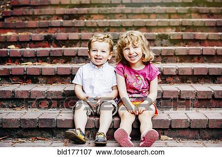 Caucasian children sitting on steps View Large Photo Image Stock Photo - Caucasian children sitting on steps. Fotosearch