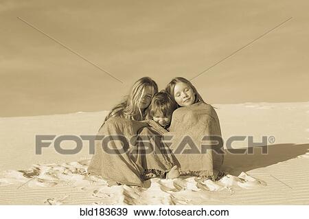 Caucasian children wrapped in blankets in desert View Large Photo Image Stock Photo - Caucasian children wrapped in blankets in desert. Fotosearch