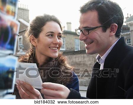 Caucasian couple admiring postcards in gift shop View Large Photo Image Stock Image - Caucasian couple admiring postcards in gift shop. Fotosearch