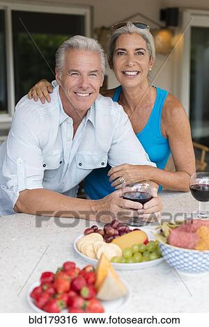 Caucasian couple drinking wine at table View Large Photo Image Stock Photograph - Caucasian couple drinking wine at table. Fotosearch