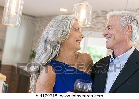 Caucasian couple drinking wine in kitchen View Large Photo Image Stock Photography - Caucasian couple drinking wine in kitchen. Fotosearch