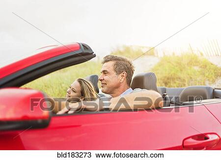 Caucasian couple driving convertible View Large Photo Image Stock Image - Caucasian couple driving convertible. Fotosearch