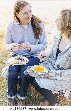 Caucasian couple eating outdoors View Large Photo Image Stock Photo - Caucasian couple eating outdoors. Fotosearch