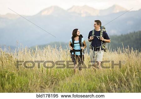 Stock Photography - Caucasian couple hiking in remote landscape. Fotosearch