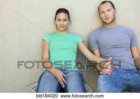 Stock Image - Caucasian couple holding hands outdoors. Fotosearch