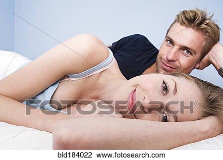 Caucasian couple hugging in bed View Large Photo Image Stock Image - Caucasian couple hugging in bed. Fotosearch