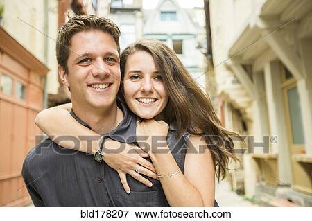 Stock Photo - Caucasian couple hugging in village. Fotosearch