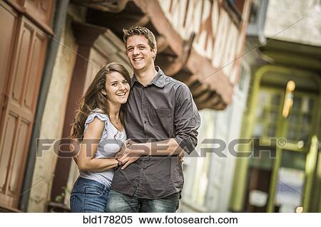 Stock Photography - Caucasian couple hugging in village. Fotosearch