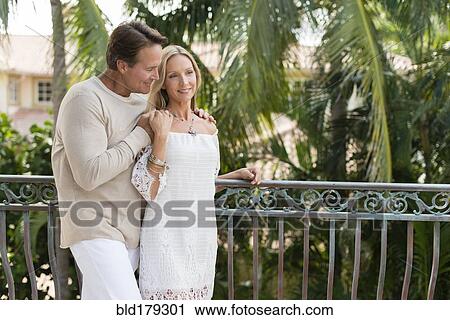 Stock Image - Caucasian couple hugging outdoors. Fotosearch