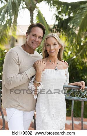 Stock Image - Caucasian couple hugging outdoors. Fotosearch