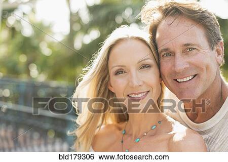 Stock Photograph - Caucasian couple hugging outdoors. Fotosearch