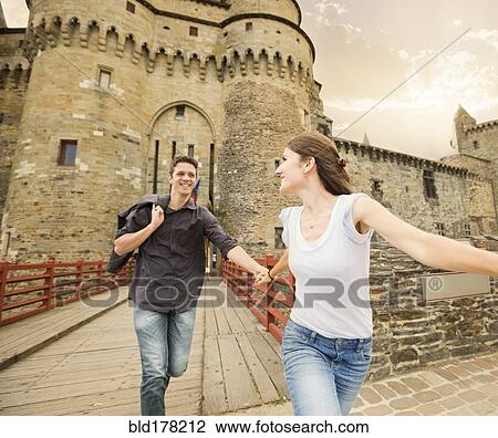 Caucasian couple running at castle View Large Photo Image Stock Image - Caucasian couple running at castle. Fotosearch