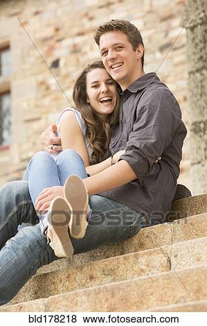 Stock Photo - Caucasian couple sitting on castle steps. Fotosearch