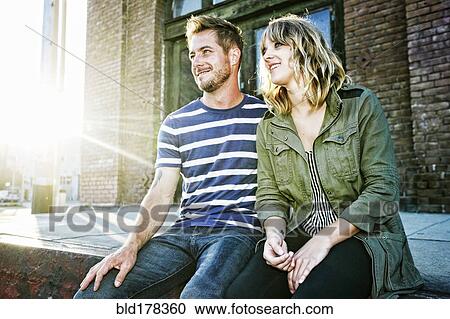 Caucasian couple sitting outdoors View Large Photo Image Stock Image - Caucasian couple sitting outdoors. Fotosearch