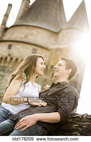 Caucasian couple smiling at castle View Large Photo Image Stock Photo - Caucasian couple smiling at castle. Fotosearch