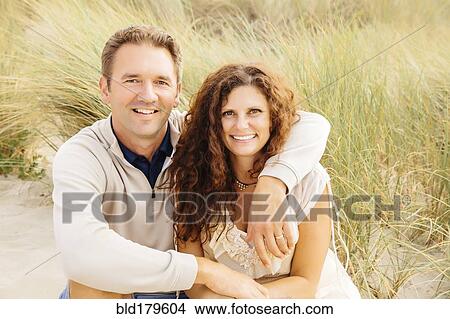 Picture - Caucasian couple smiling on beach. Fotosearch
