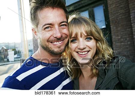Stock Image - Caucasian couple smiling outdoors. Fotosearch