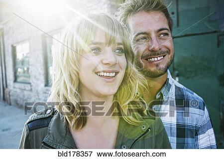 Caucasian couple smiling outdoors View Large Photo Image Stock Photo - Caucasian couple smiling outdoors. Fotosearch