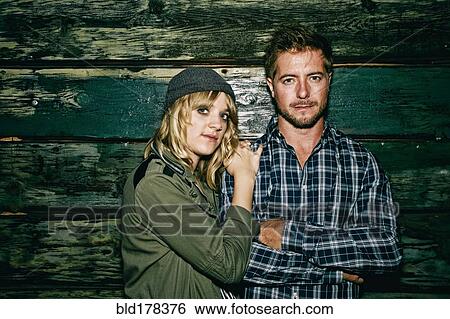 Caucasian couple standing at wooden wall View Large Photo Image Stock Photograph - Caucasian couple standing at wooden wall. Fotosearch