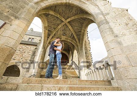 Stock Photograph - Caucasian couple standing on castle steps. Fotosearch