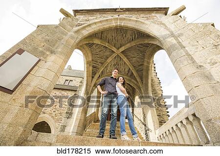 Stock Photography - Caucasian couple standing on castle steps. Fotosearch