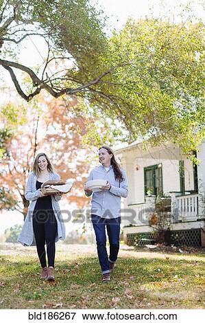 Caucasian couple walking in backyard View Large Photo Image Stock Photo - Caucasian couple walking in backyard. Fotosearch