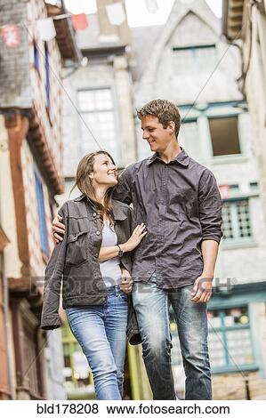 Stock Photo - Caucasian couple walking in village. Fotosearch