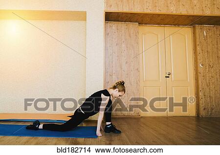 Picture - Caucasian dancer stretching in studio. Fotosearch