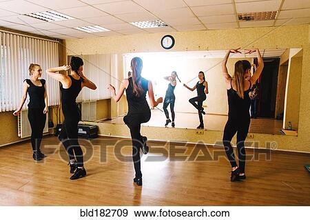 Stock Photo - Caucasian dancers practicing in studio. Fotosearch