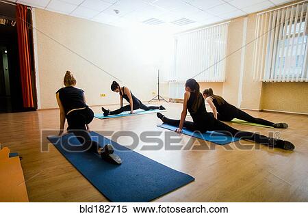 Caucasian dancers stretching in studio View Large Photo Image Stock Photography - Caucasian dancers stretching in studio. Fotosearch