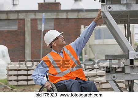Stock Image - Caucasian engineer working on construction site. Fotosearch