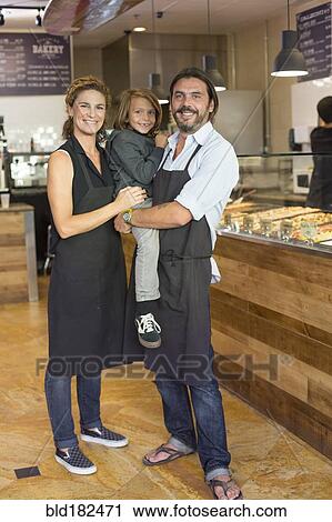 Caucasian family business owners smiling in cafe View Large Photo Image Stock Image - Caucasian family business owners smiling in cafe. Fotosearch