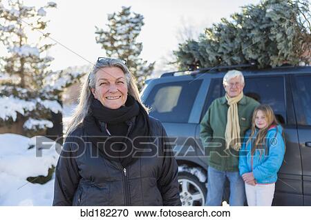 Caucasian family hauling Christmas tree View Large Photo Image Stock Image - Caucasian family hauling Christmas tree. Fotosearch